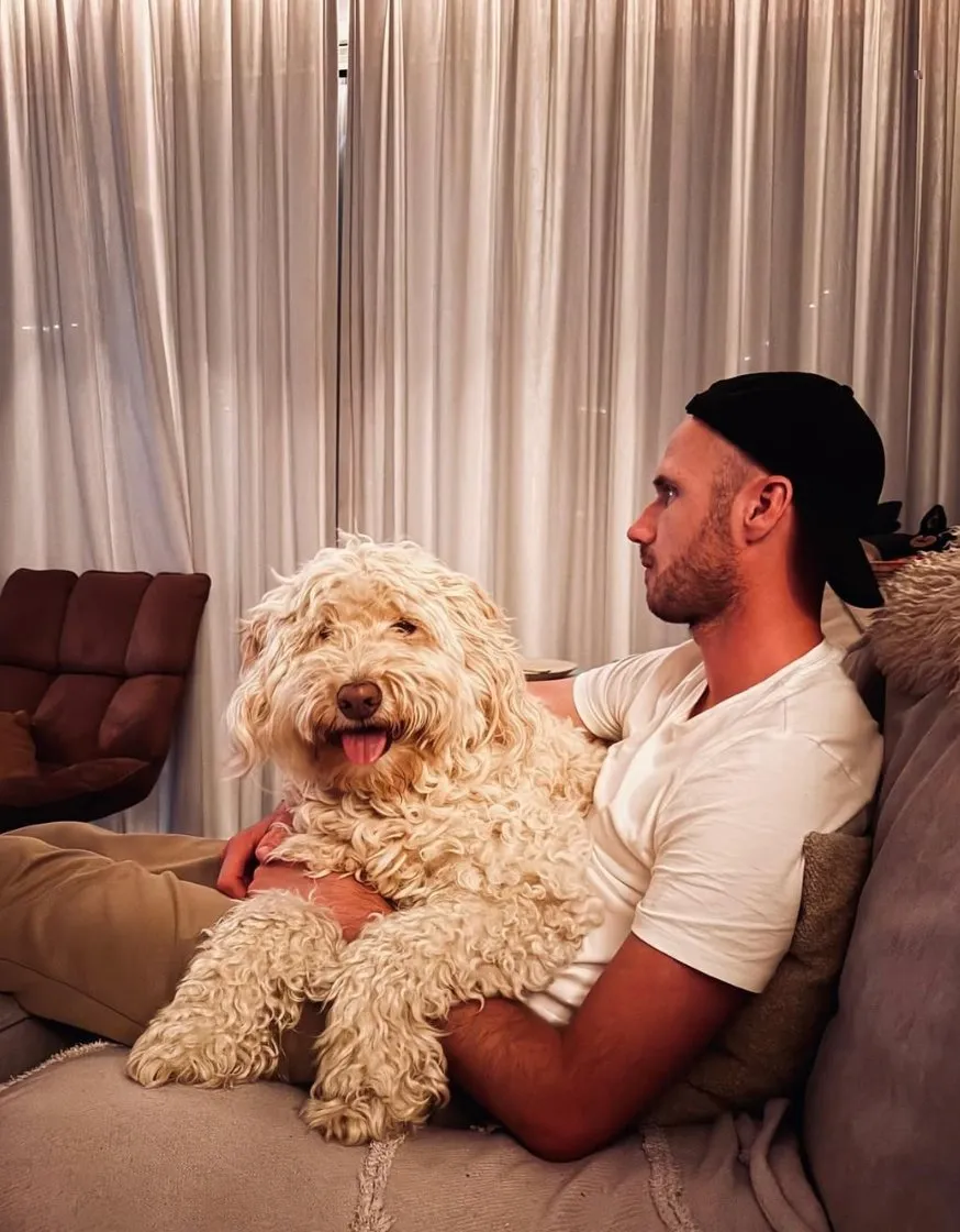 Rob met Soofi de Labradoodle samen op de bank